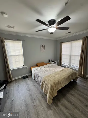 a bedroom with a large bed and a large window