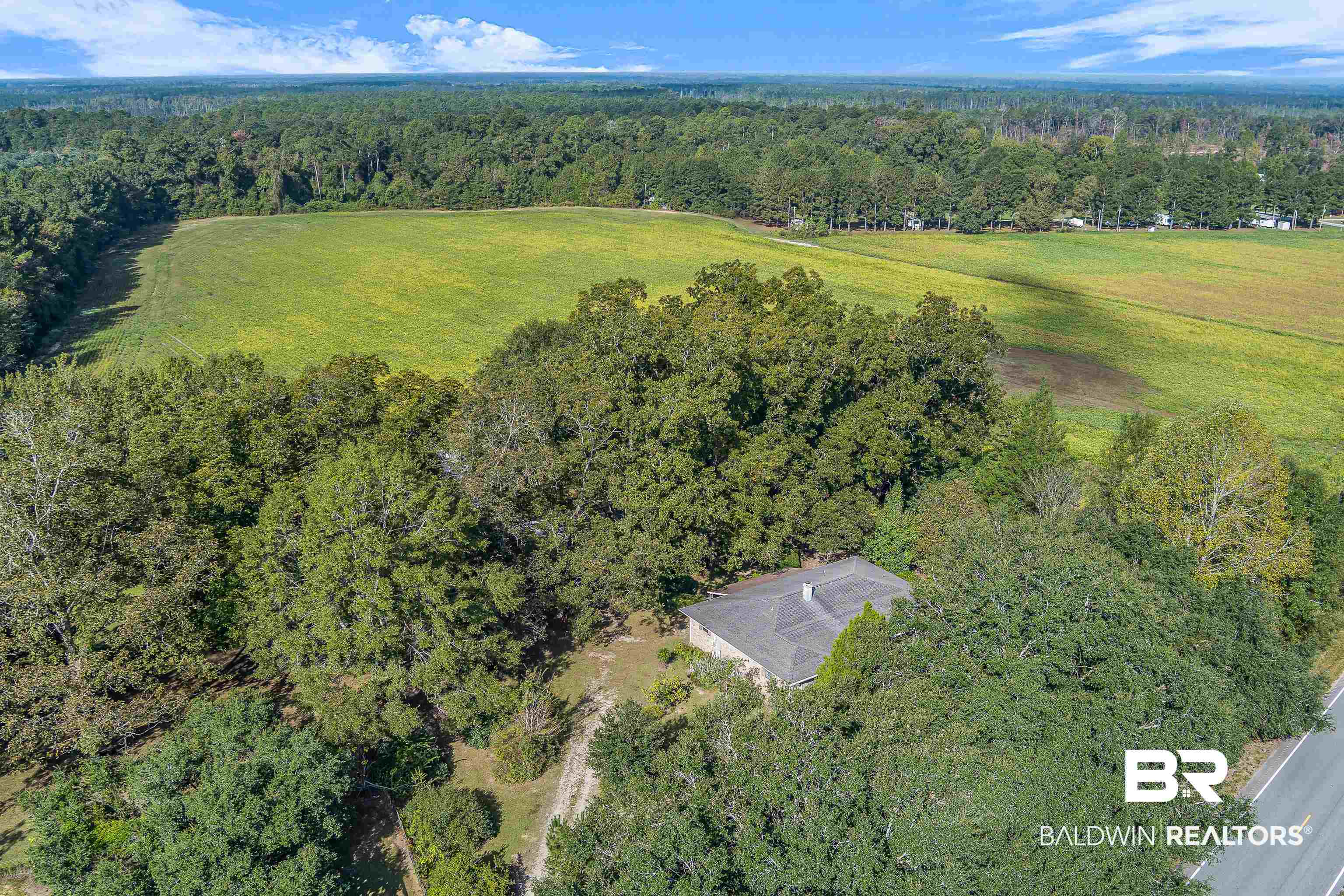 72075 Highway 59 Little River, AL 36550 - Photo 37 of 40 Aerial view of property and surrounding area with a heavily wooded area