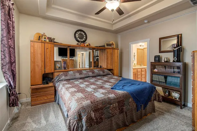 a bedroom with a bed a dresser and a book shelf