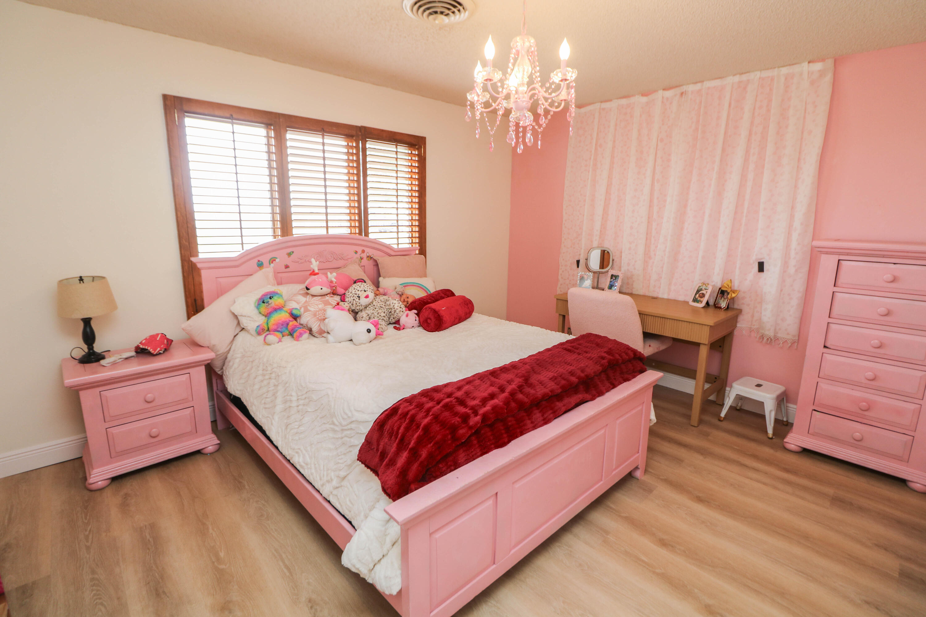 1740 Highway 70 Springlake, TX 79082 - Photo 12 of 39 a bedroom with a bed and a chandelier