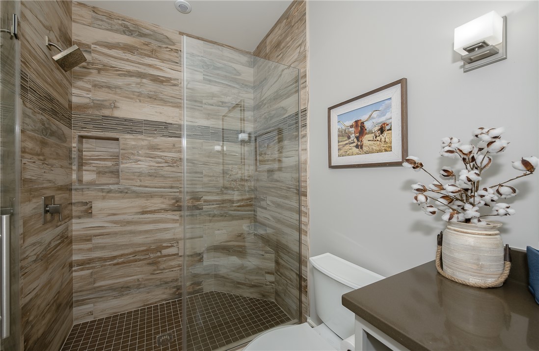 3320 Sycamore Trail Bryan, TX 77807 - Photo 39 of 48 Bathroom featuring toilet, vanity, and a stall shower
