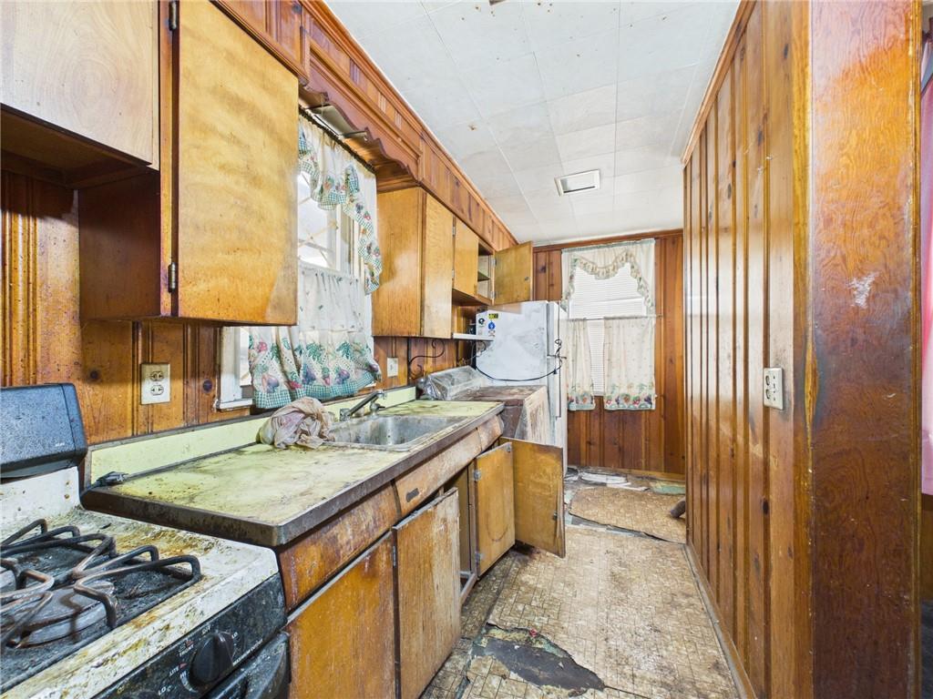 21 Ruth Street Pittsburgh, PA 15211 - Photo 11 of 18 a kitchen with a stove a sink and a refrigerator