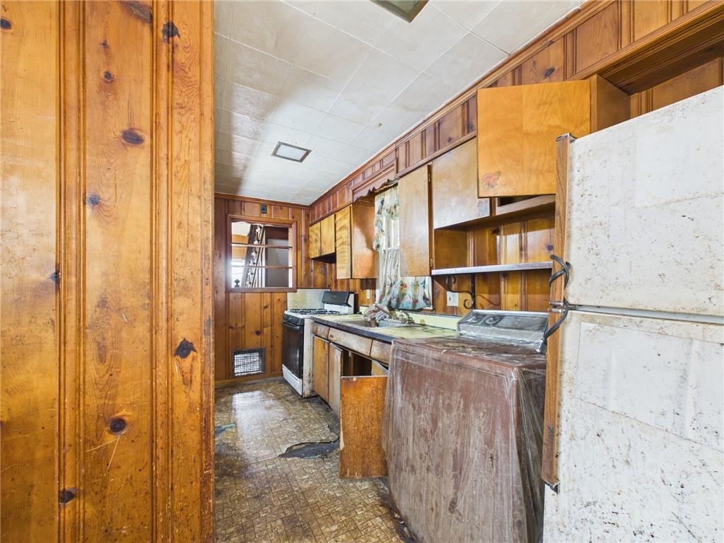 21 Ruth Street Pittsburgh, PA 15211 - Photo 12 of 18 a kitchen with stainless steel appliances granite countertop a stove and a refrigerator