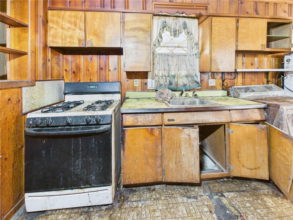 21 Ruth Street Pittsburgh, PA 15211 - Photo 10 of 18 a kitchen with a stove and a table