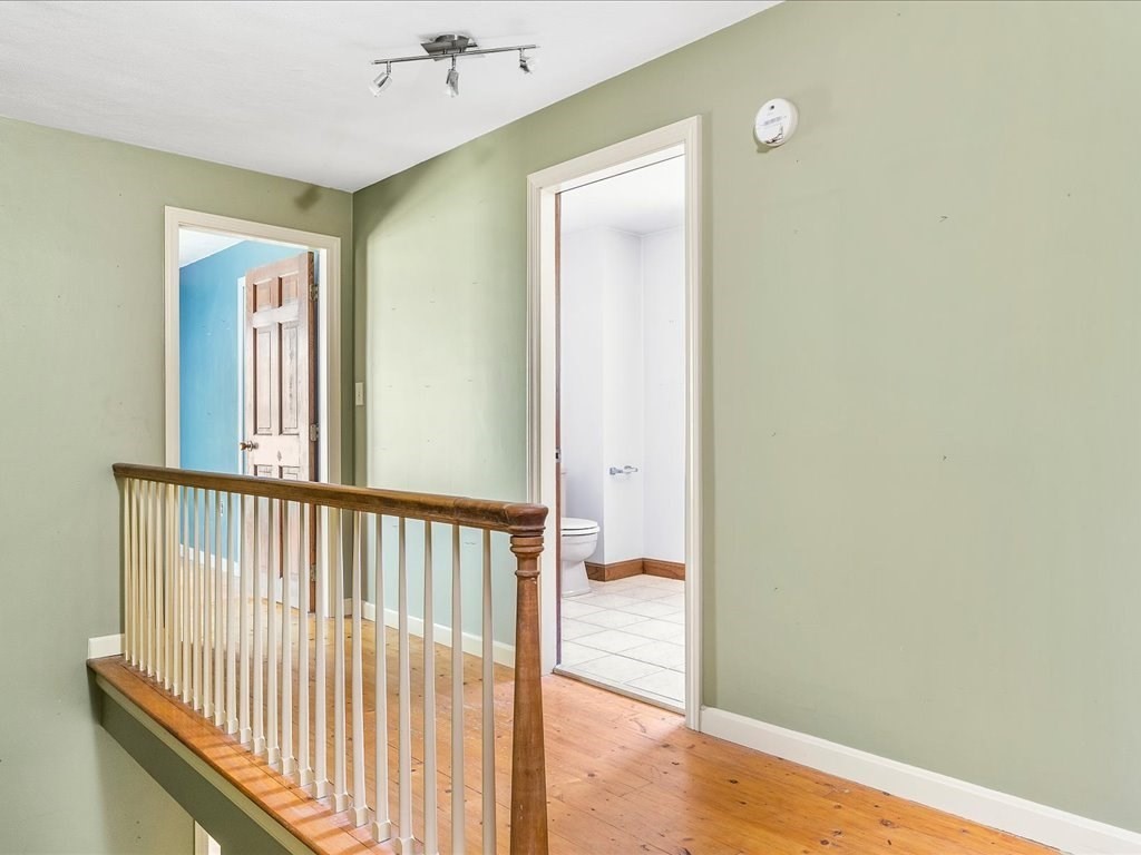 109 Amy Hart Path Little Compton, RI 02837 - Photo 23 of 39 a view of a hallway with wooden floor and staircase
