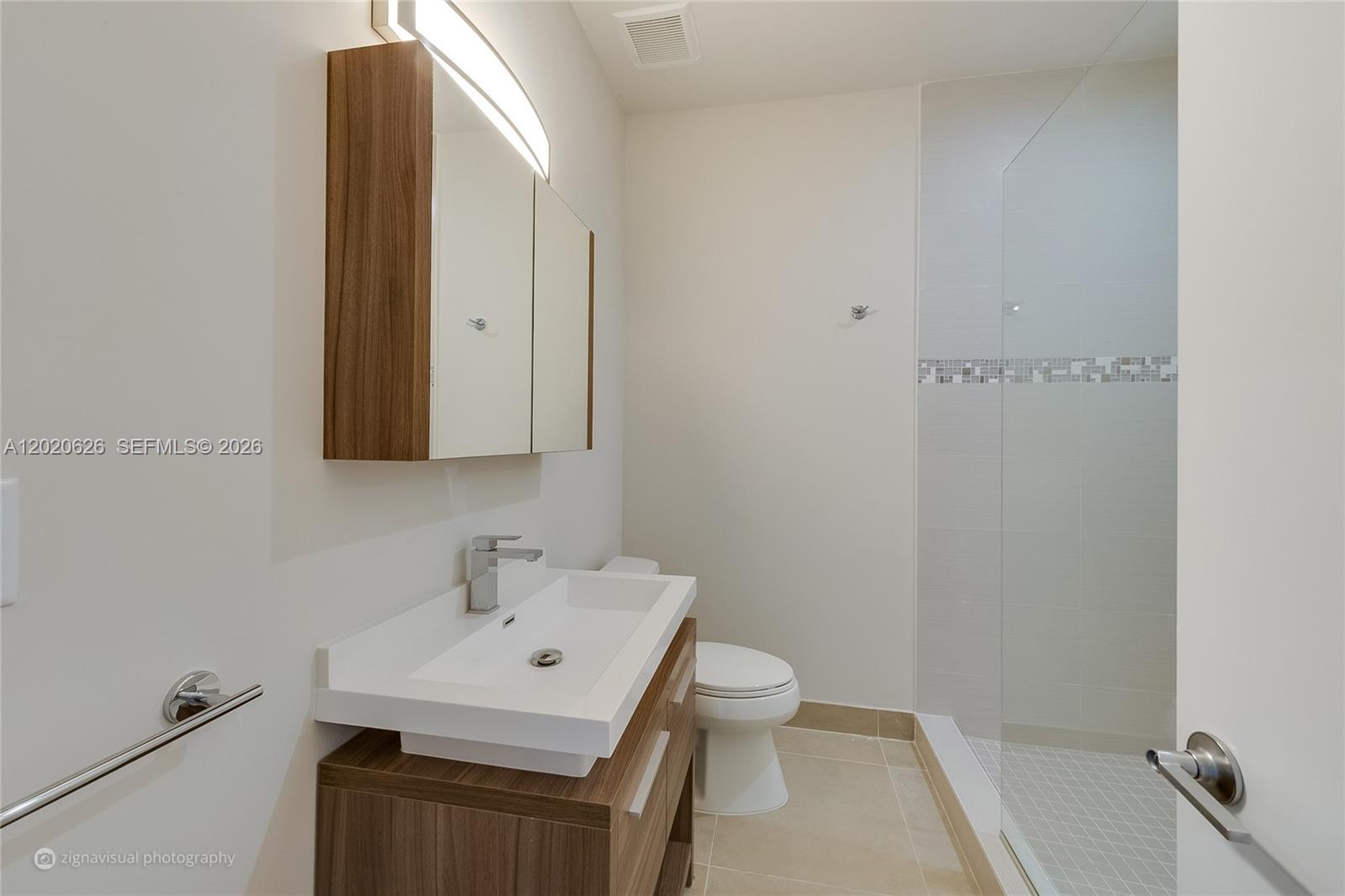 7701 Southwest 95th Terrace, Unit 1 Miami, FL 33156 - Photo 14 of 18 a bathroom with a sink toilet and vanity