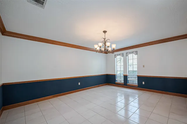 a view of an empty room with a ceiling fan