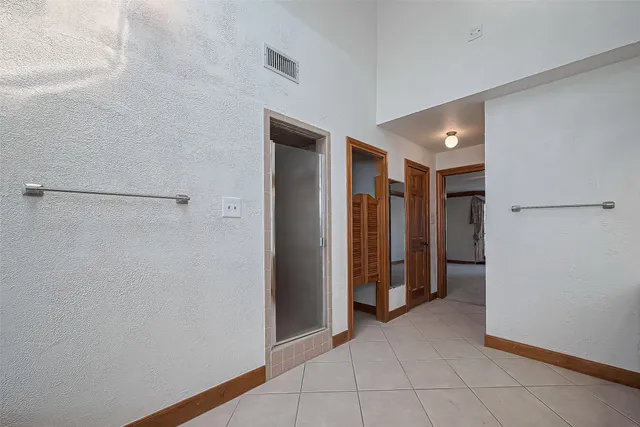 a yellow house with trees in front of it