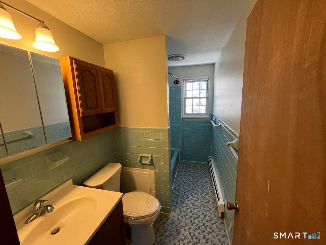 633 Center Street, Unit E Manchester, CT 06040 - Photo 15 of 15 a bathroom with a sink toilet and shower