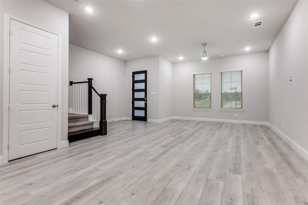 1888 Strand Street Dallas, TX 75234 - Photo 2 of 13 Open-concept living space with light wood-finish flooring, recessed lighting, and a modern ceiling fan