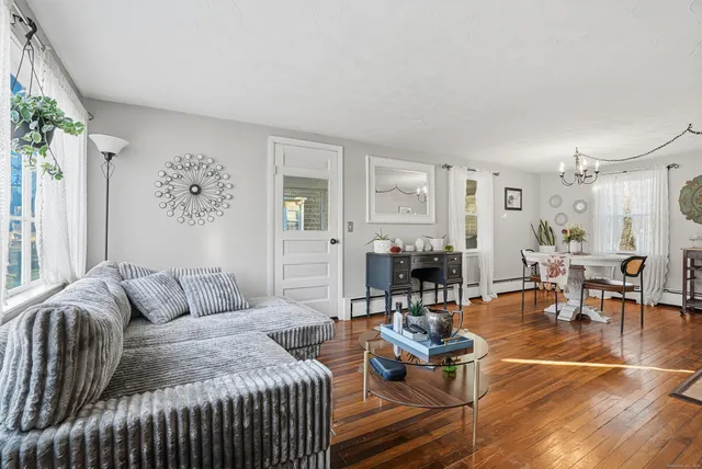 a view of a dining room with furniture and wooden floor