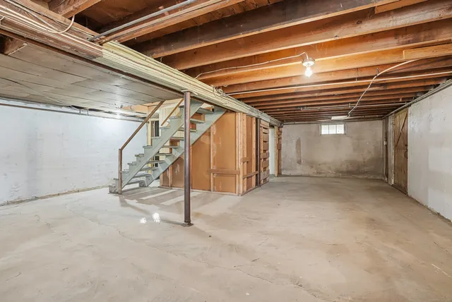 a view of empty room with wooden ceiling