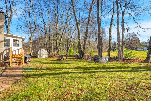 a front view of a house with outdoor seating