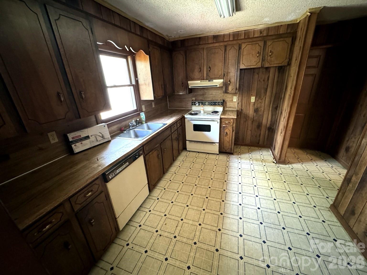 3968 Dover Street Claremont, NC 28610 - Photo 5 of 20 a kitchen with a sink a refrigerator and a stove