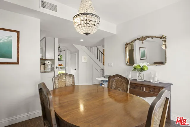 a dining room with furniture and chandelier