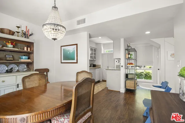 a view of a dining room with furniture wooden floor and a chandelier