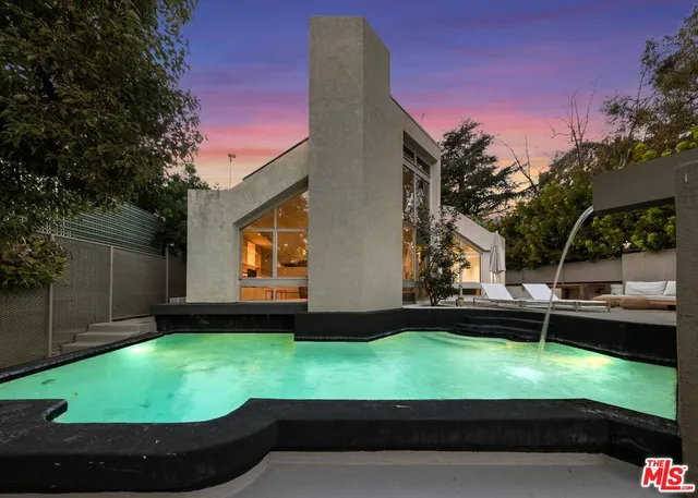 a view of a backyard with sitting area