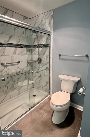 a view of an empty room with window and cabinet