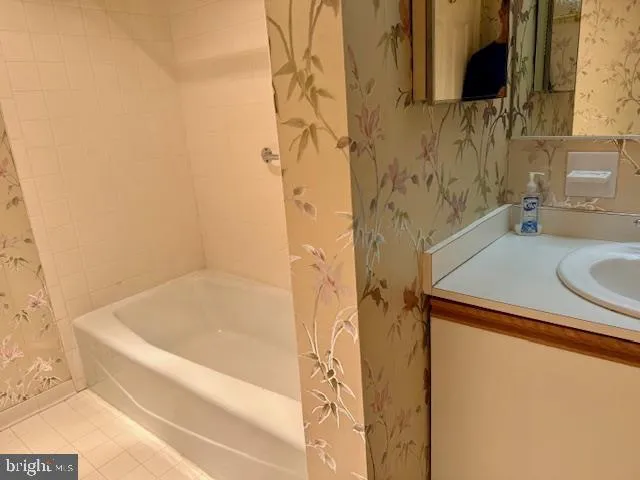a spacious bathroom with a double vanity sink and a mirror