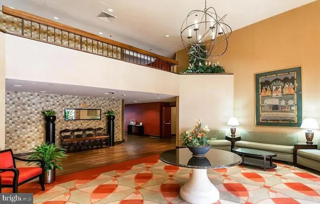 a living room with furniture and a chandelier