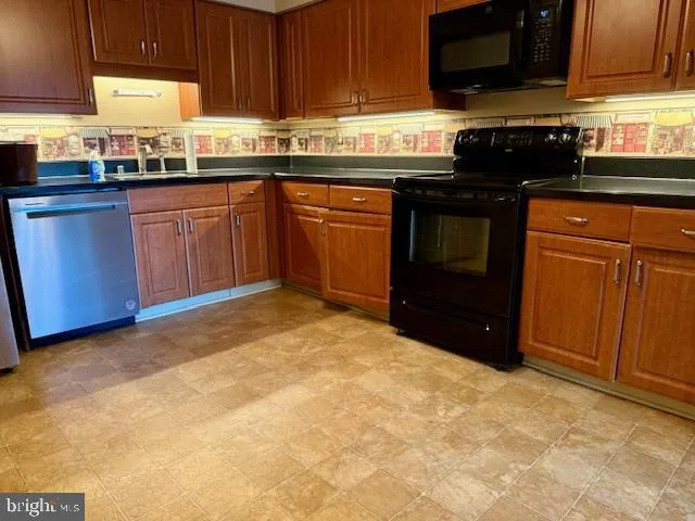 a kitchen with granite countertop a sink stove and cabinets