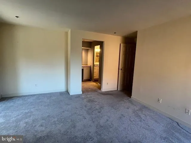 an empty room with closet and a sink
