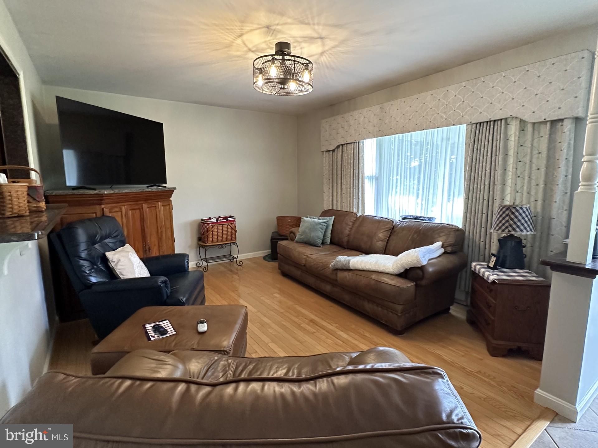 28402 Liden School Road Denton, MD 21629 - Photo 13 of 59 a living room with furniture and a flat screen tv
