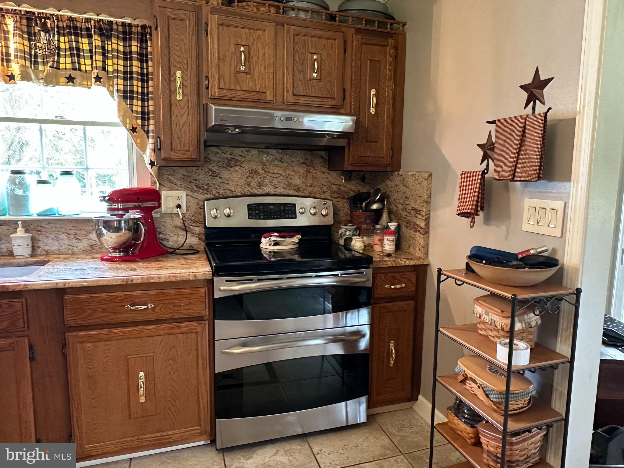 28402 Liden School Road Denton, MD 21629 - Photo 18 of 59 a kitchen with stainless steel appliances granite countertop a stove and a refrigerator