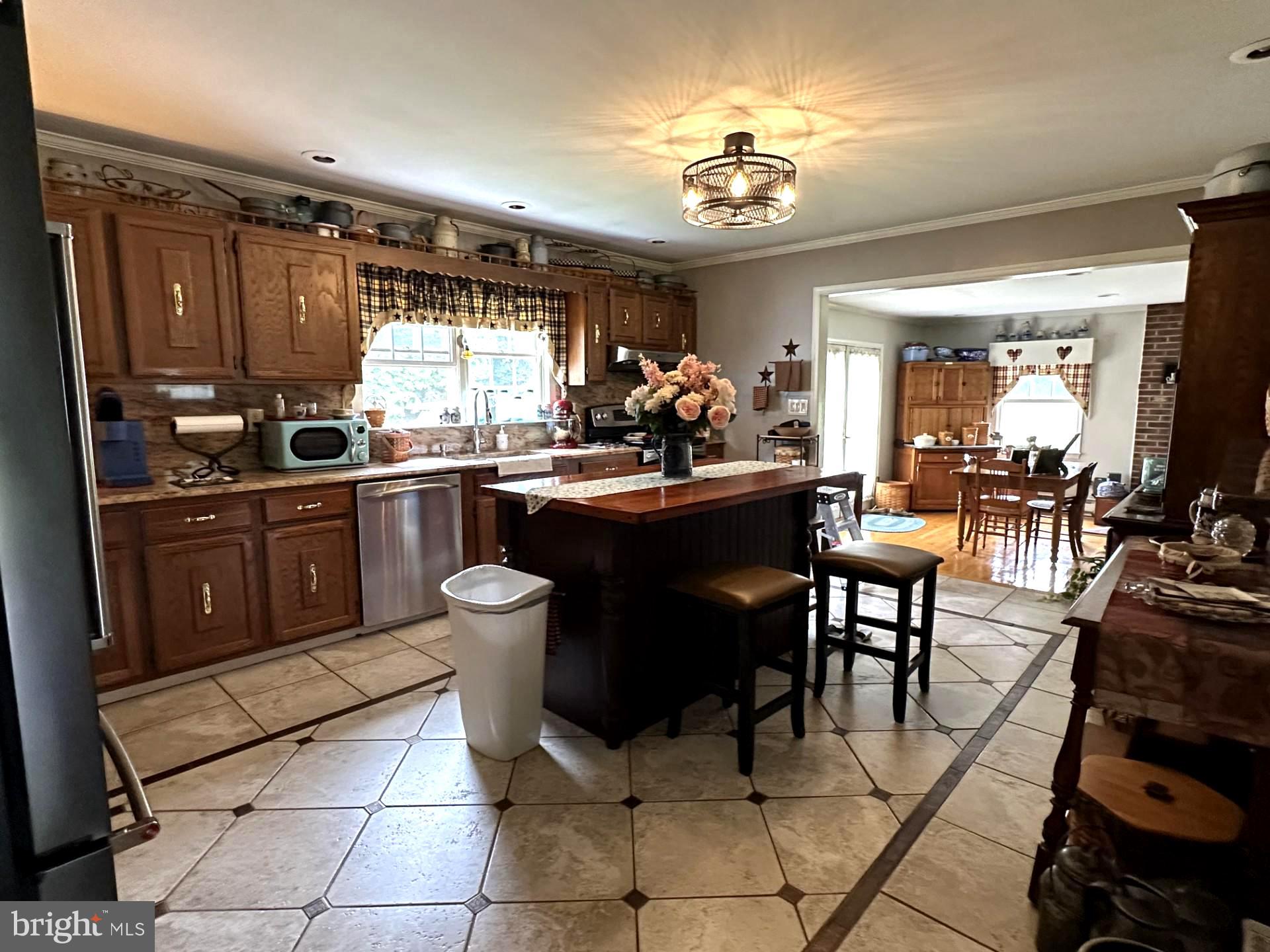 28402 Liden School Road Denton, MD 21629 - Photo 27 of 59 a kitchen with a dining table and chairs