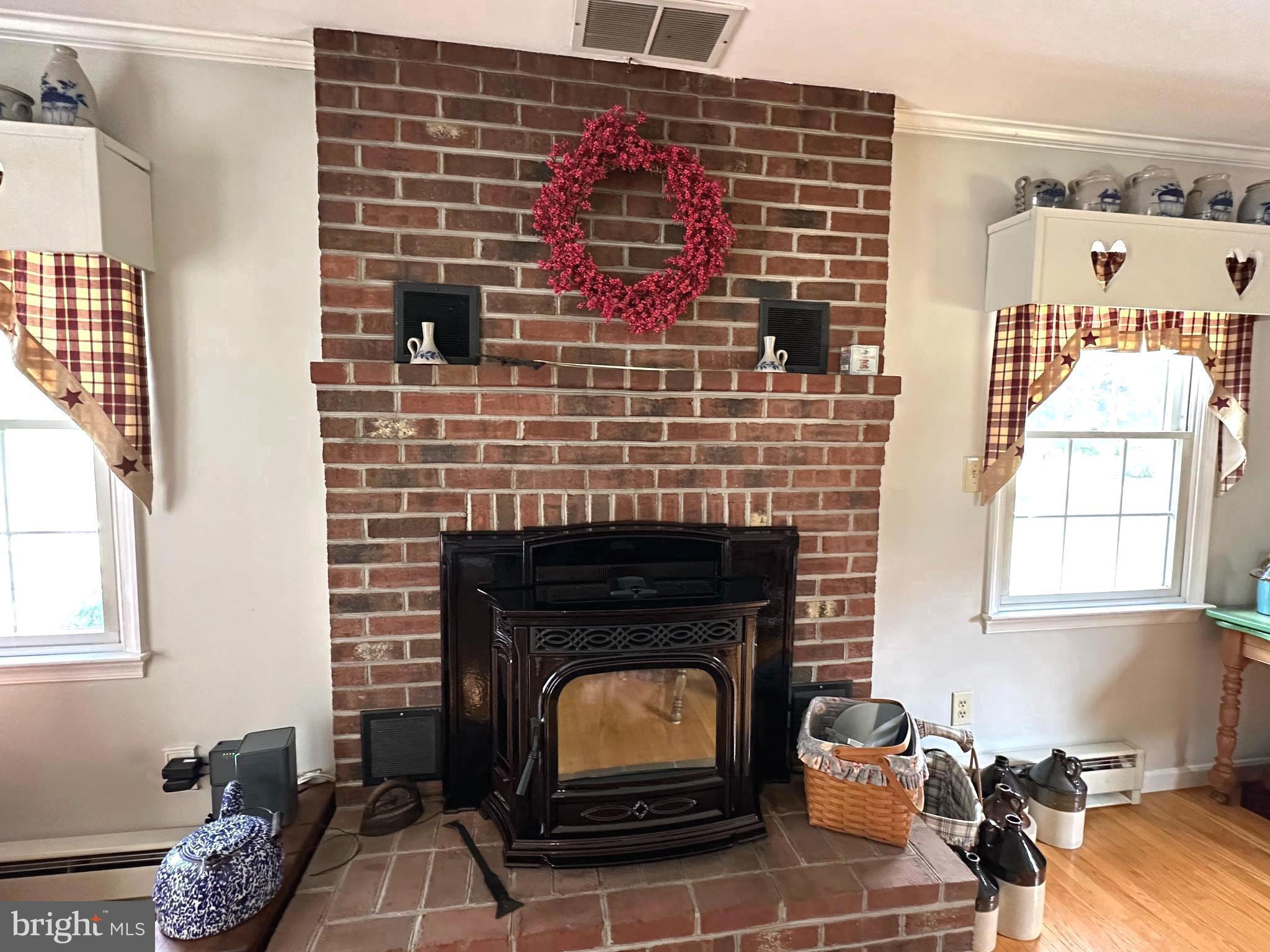 28402 Liden School Road Denton, MD 21629 - Photo 32 of 59 a living room with furniture a fireplace and a window