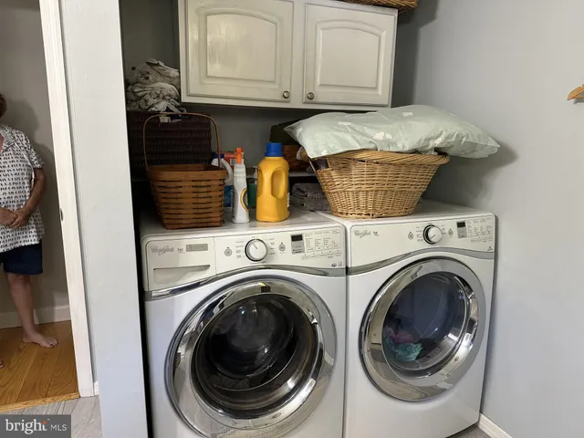 a bathroom with a granite countertop toilet sink and mirror