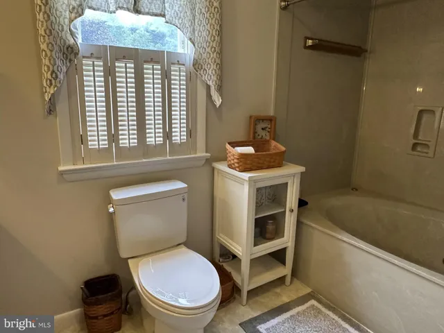 a view of a chairs and table in patio with a barbeque grill