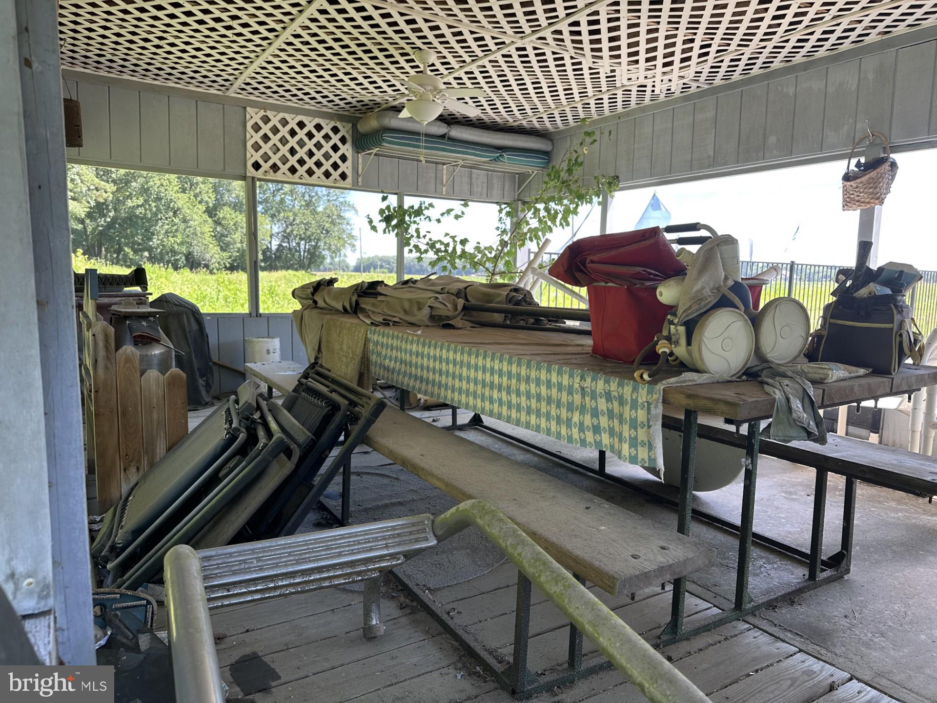 28402 Liden School Road Denton, MD 21629 - Photo 53 of 59 a view of a chairs and table in patio with a barbeque grill