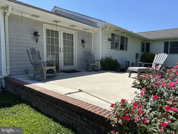 a view of a house with a big yard and large trees