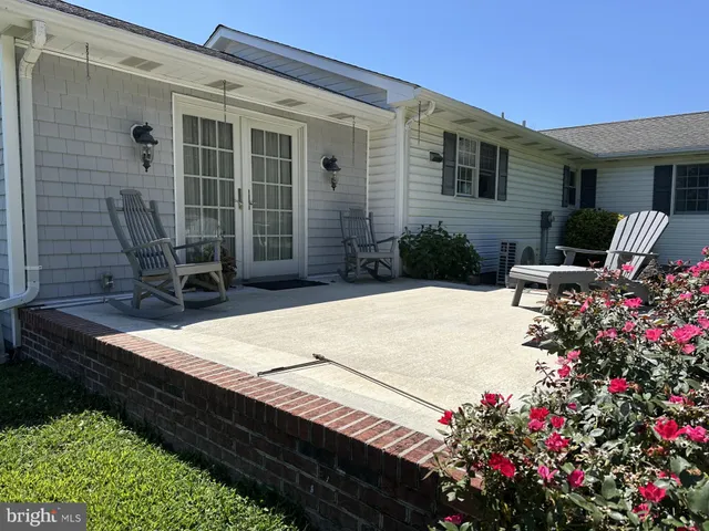 a view of a house with a big yard and large trees