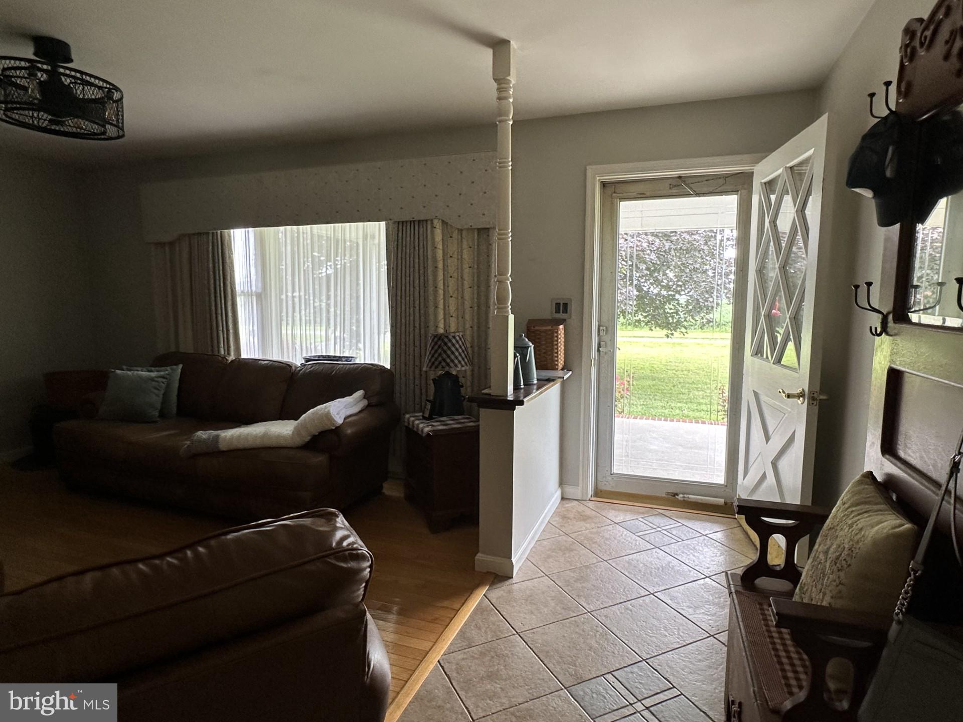 28402 Liden School Road Denton, MD 21629 - Photo 8 of 59 a living room with furniture a flat screen tv and a window