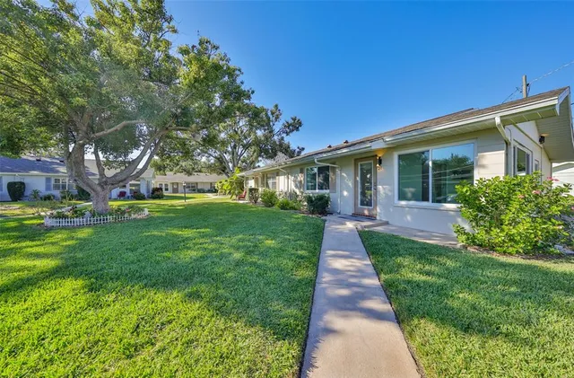 a front view of house with yard and green space