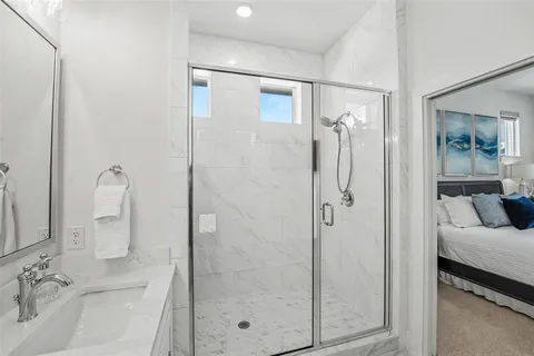 a bathroom with a shower sink and mirror