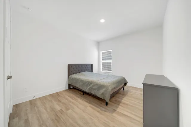 a bedroom with a bed and a lamp