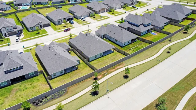 an aerial view of a house with a swimming pool