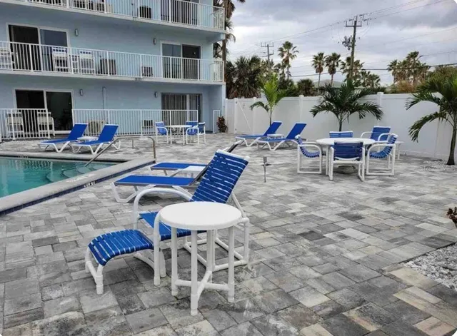 a view of a patio with a dining table and chairs