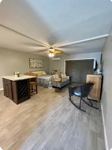 a living room with furniture and a wooden floor
