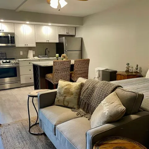 a living room with furniture and a lamp