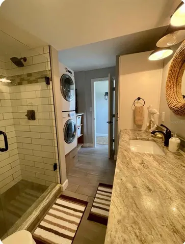 a bathroom with a sink mirror and shower