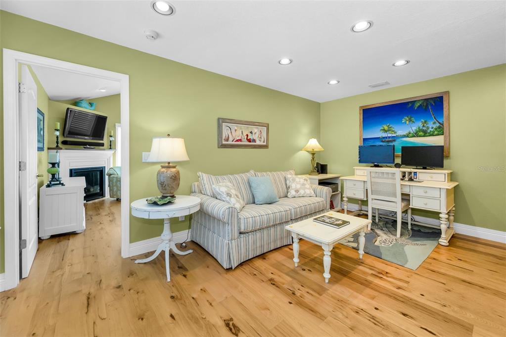 13303 Gulf Lane Madeira Beach, FL 33708 - Photo 29 of 42 a living room with furniture a flat screen tv and kitchen view