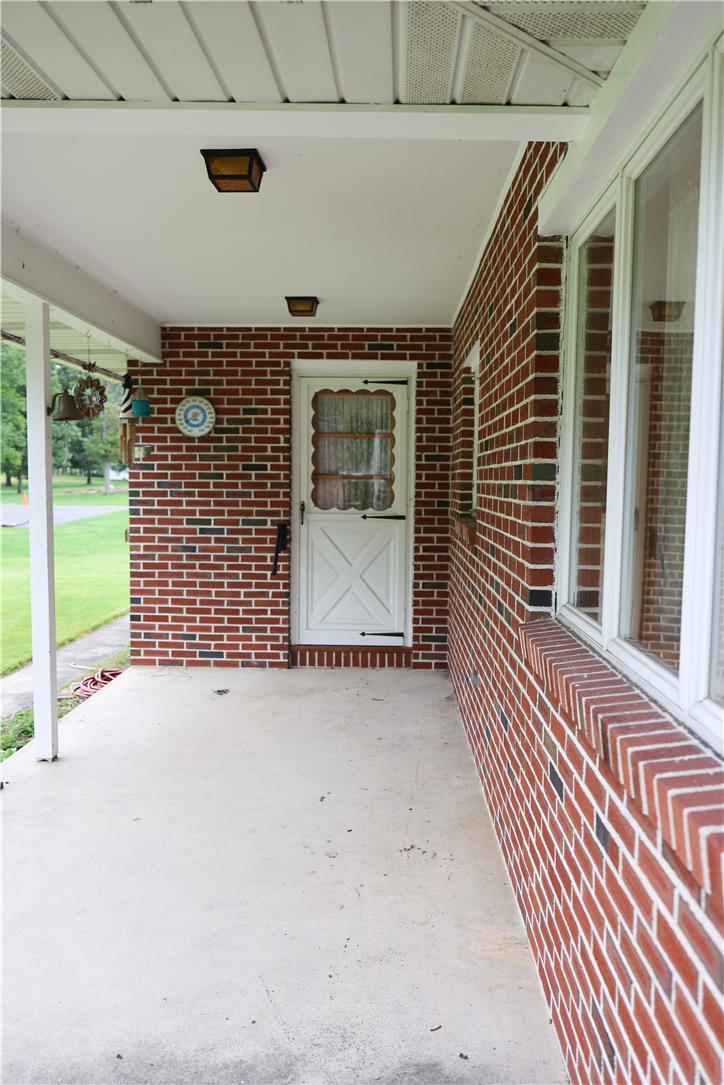 134 Bangor Junction Road Bangor, PA 18013 - Photo 3 of 18 Classical brickwork frames a covered concrete porch leading to the home entry.