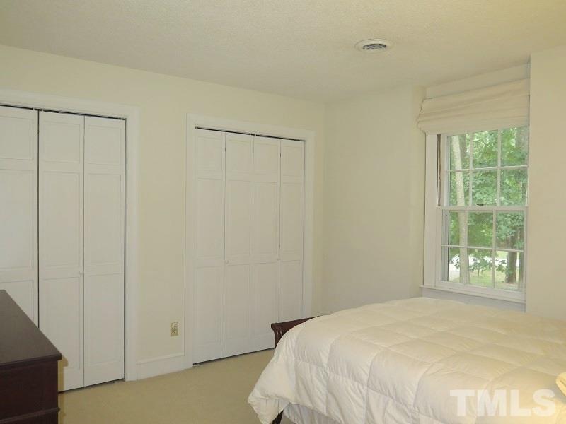 11501 Coachmans Way Raleigh, NC 27614 - Photo 13 of 20 a bedroom with a bed and a window