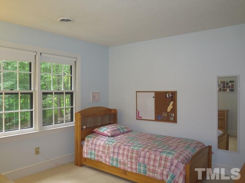 11501 Coachmans Way Raleigh, NC 27614 - Photo 14 of 20 a bedroom with a bed and a flat screen tv