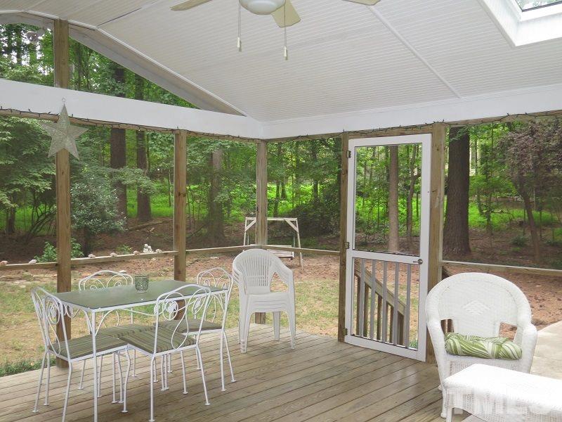 11501 Coachmans Way Raleigh, NC 27614 - Photo 17 of 20 a dining room with wooden floor glass table and chairs