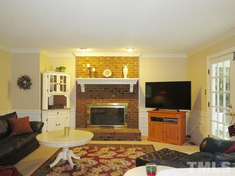 11501 Coachmans Way Raleigh, NC 27614 - Photo 5 of 20 a living room with furniture a flat screen tv and a fireplace